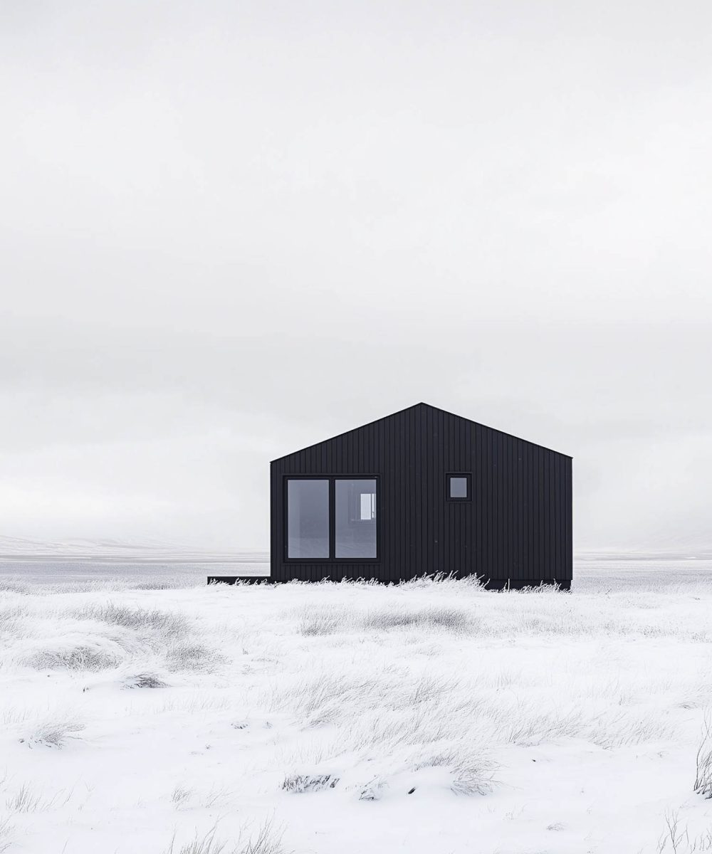 Solitary Modern Black Cabin in Snowy Landscape